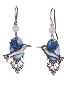 PRICES MAY VARY. Features a layered hummingbird design. Dangles from silver-tone surgical steel French ear wires. Each piece comes wrapped with tissue in a gift box and tied with a ribbon. 1.50" long drop. Handcrafted in the USA. Complete your look with an ethereal touch. These earrings feature a silver-tone hummingbird with blue hand-painted wings. Floats upon a light blue oval disc and a silver-tone ornate filigree charm. Accented with light blue beads. Painted Wings, Hummingbird Design, Blue Hand, Silver Filigree, Blue Beads, Ear Wires, Dangle Drop Earrings, Silver Tone, Light Blue