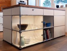 a cabinet with wine glasses and bowls in it