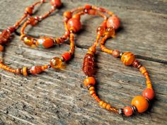 "------------------------------------------------------------------- Long Orange Necklace handmade by reccabella ------------------------------------------------------------------- This long necklace is a great piece, I have made it from hundreds of different beads in various shades of orange. The mixture of materials such as wood, glass, ceramic etc makes this a really interesting necklace. The variations of shade also adds to the uniqueness of the piece. I have added some antique bronze effect Orange Bohemian Beaded Necklaces For Jewelry Making, Bohemian Orange Beaded Necklaces For Jewelry Making, Bohemian Orange Beads For Jewelry Making, Bohemian Orange Long Necklace, Bohemian Long Necklace With Round Beads For Gifts, Bohemian Orange Beads For Gifts, Bohemian Orange Beaded Chain Necklace, Bohemian Single Strand Necklace, Bohemian Orange Single Strand Beads