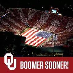 a large american flag in the middle of a stadium