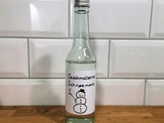 a bottle of water with a snowman sticker on it