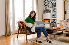 a woman sitting on a chair in a living room