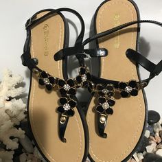 Elegant Comfortable Black Sandals Brand New. Price Is Firm Black T-strap Sandals For Summer, Black Round Toe T-strap Sandals For Summer, Black T-strap Sandals For Summer Vacation, Black Summer T-strap Sandals For Beach, Black Flat T-strap Sandals For Spring, Black Ankle Strap Summer Sandals, Black T-strap Sandals For Spring Party, Black T-strap Sandals For Spring Vacation, Black Toe Post Sandals For Beach