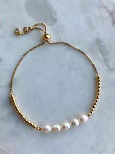 Perfect to layer or wear alone, Whether you like your bracelets loose or close to the wrist, our freshwater pearl gold Adjustable Chain Bracelet in White Pearl is a delicate addition to any arm party. This stunning chain bracelet is a perfect go-to for everyday wear and adds a little extra sparkle to your outfit. Wear it alone or stack on more for a trend-forward look. Classic jewelry vibe combined with the fashion-forward trend. Sightly adjustable, comfortable for daily wear, suitable for every Elegant Gold Bangle Friendship Bracelets, Elegant Adjustable Hypoallergenic Rosary Bracelet, Elegant Adjustable Friendship Bracelets, Adjustable White Gold Hypoallergenic Bracelet, Elegant Friendship Bracelets With Adjustable Chain, Elegant Adjustable Bracelets For Friendship, Minimalist Adjustable Pearl Bracelet With Extender, Elegant Adjustable Bracelet For Friendship, Dainty White Bracelets With Adjustable Length