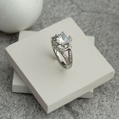 A wonderful ring to accompany you on your special days. Also great as a gift to your loved ones. We wrap it beautifully as a gift wrap for you. 💎 9 mm cubic zircone, 6 pieces of small baguette zircon,  it is decorated with 6 round zircon stones and 24 small zircon stones 💎 Big Zircon Silver Ring it will add sparkle to your glow. 💎 It is decorated with one large zircon stone with a hexagon shape of 9 mm in size and small zircon stones around it. 💎 It is specially made according to your finger Classic Promise Crystal Ring With Gemstone, Classic Crystal Ring With Cubic Zirconia, Cubic Zirconia Diamond Ring With Accent Stones As Gift, Formal Cubic Zirconia Birthstone Ring With Accent Stones, Dazzling Diamond White Sapphire Ring Gift, White Topaz Round Birthstone Ring, White Topaz Gemstone Rings With Round Cut, Gift Diamond Ring With Open Design, Gift Diamond Ring With Open Shape