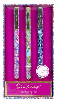 three colorful pens in a pink box with floral designs on it and the words love ribbon written