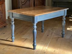 a wooden table sitting on top of a hard wood floor