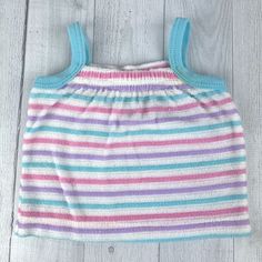 Cute striped tank top in purple, white, blue and pink. Terry cloth type material. Stripes have raised texture feel. Blue straps. Elastic at neckline. Pull over. Size: 9 months Measurements (approximate): Shoulder to Hem: 9.5" Armpit to Armpit: 8" Brand: Carrot Top Condition: Spot on front stripe, see pictures for details. Be sure to check out my shop! New items added often! https://www.etsy.com/shop/AutumnRoseArtVintage Summer Texture, Carrot Top, Top Summer, Striped Tank Top, Striped Tank, Sleeveless Shirt, Terry Cloth, Girl Top