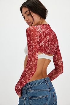 Take every look up a notch with this head-turning bolero featured in a classic cropped, long sleeve style and semi-sheer, floral-printed fabrication to add a sweet, femme finishing touch to every ‘fit. | Rita Bolero by Only Hearts at Free People in Red, Size: M Sheer Sleeves Fitted Crop Top For Fall, Floral Print Stretch Cropped Top, Stretch Floral Print Cropped Top, Fitted Crop Top With Sheer Sleeves For Fall, Stretch Cropped Floral Print Crop Top, Chic Long Sleeve Floral Print Crop Top, Chic Floral Print Crop Top For Fall, Summer Crop Top With Sheer Sleeves, Fall Crop Top With Sheer Sleeves