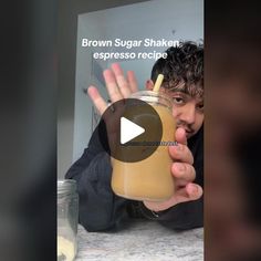 a man holding up a drink in front of his face with the caption brown sugar shaker espresso recipe