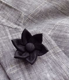 A black silk lapel pin flower boutonniere for elegant men and women, made in the Japanese tsumami kanzashi style! I used a black dupioni silk to make the flower, added a cover button to the center, and mounted it on a tie tack with butterfly clutch back. Complements a suit, blazer, vest, hat, or sports jacket. Kanzashi flowers are made from folded fabric squares, one petal at a time. Originally, apprentice geisha made kanzashi hair accessories from their old kimonos. DETAILS  ---dupioni silk ... Classic Black Brooches For Wedding, Classic Black Brooches For Formal Occasions, Classic Black Wedding Brooches, Classic Black Wedding Brooch, Classic Black Formal Brooches, Elegant Black Business Lapel Pin, Classic Black Lapel Pin For Formal Occasions, Elegant Formal Brooches With Handmade Flowers, Black Formal Brooch Lapel Pin