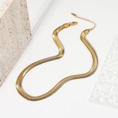 The Bold Herringbone Necklace in 18k gold plating makes a striking statement. Its wide, sleek design captures light beautifully, adding an element of sophisticated shine to any outfit, from casual to formal. Elegant Gold Plated Herringbone Necklace With Box Chain, Elegant Gold-plated Herringbone Necklace With Box Chain, Elegant Formal Herringbone Chain Necklace, Elegant Formal Herringbone Necklace, Elegant Gold-tone Snake Chain Necklace As Gift, Chic Formal Necklaces With Snake Chain, Elegant Gold-tone Snake Chain Necklace, Elegant Gold Herringbone Choker Necklace, Chic Formal Snake Chain Necklaces