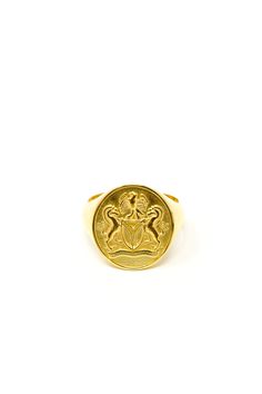 a gold ring with an emblem on it