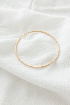 14k gold filled 2mm hammered textured bangle Please note: this bangle is hand-stamped so the stamping may not be perfect If you would like a different length that is not listed, please contact us for a custom order! Finding Your Size We recommend using a flexible measuring tape to wrap around your wrist to find the length of your preferred fit. An alternative to this is getting a piece of string or shoelace, wrap that around your wrist, and measure the length in inches Everyday 14k Gold-filled Bangle Bracelet, Everyday 14k Gold Filled Bangle Bracelet, Minimalist Hammered Bangle For Everyday, Minimalist Hammered Round Bangle, Minimalist Everyday Hammered Bangle, Everyday Minimalist Hammered Bangle, Everyday Hammered Bangle Bracelets, Hammered Yellow Gold Bangle For Everyday, Everyday Hammered Bangle Bracelet