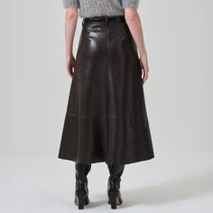 High rise flared midi skirt Zip fly Fabric: 50% recycled leather, 30% polyurethane, 10% viscose, 10% polyester Fully lined Length: 34" We suggest getting your normal size Made in the USA 3187-3013 Taupe Leather Midi Skirt, Brown Faux Leather Midi Skirt, Chic Knee-length Faux Leather Skirt, Sleek Knee-length Leather Skirt, Leather Knee-length Lined Skirt, Midi Flare Skirt, Velvet Coat, Skirt Jumpsuit, Recycled Leather