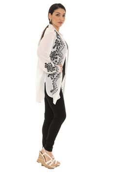 Find Indian-inspired style in this long-sleeve top that has detailed embroidery and buttons at the top. Size S: 27.5'' long from high point of shoulder to hem Woven 100% cotton Machine wash Long Sleeve Cotton Blouse With Embroidered Cuffs, Casual Long Sleeve Embroidered Blouse, Casual Cotton Blouse With Embroidered Cuffs, Fall Cotton Blouse With Embroidered Cuffs, Cotton Long Sleeve Tops With Embroidered Cuffs, Summer Long Sleeve Blouse With Embroidered Cuffs, Long Sleeve Blouse With Embroidered Cuffs, Cotton Long Sleeve Blouse With Floral Embroidery, Long Sleeve Cotton Embroidered Top With Cuffs