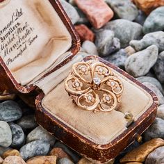 This pretty vintage seed pearl and diamond brooch is in the shape of a circle and is centered with an Old Mine cut diamond. The openwork of the gold is set with seed pearls. The brooch pin is crafted in 10k yellow gold with a fantastic patina. Old Mine Cut Diamond, Diamond Brooch, Edwardian Era, European Cut Diamonds, Art Deco Era, Seed Pearl, Pearl Diamond, Brooch Pin, Diamond Cuts