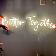 two neon signs that say better together