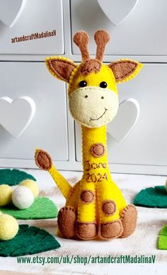 a stuffed giraffe sitting on top of a table