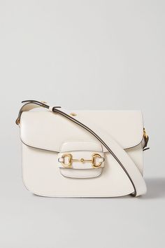 Gucci's '1955' bag looks just like a vintage one, thanks to its timeless silhouette and iconic gold hardware. Expertly made in Italy from white textured-leather, it's topped with the house's equestrian horsebit, which was debuted in the '50s. It's perfectly sized for daily essentials and has three compartments for easy organization. -- White textured-leather (Calf) - Tab-fastening front flap - Comes with dust bag - Weighs approximately 3.3lbs/ 1.5kg - Made in Italy Gucci Crossbody Satchel With Gold-tone Hardware, Chic Gucci Top Handle Satchel, Chic Gucci Shoulder Satchel, Chic Gucci Crossbody Satchel, Gucci Satchel With Gold-tone Hardware, Gucci Shoulder Satchel With Gold-tone Hardware, Gucci Bags With Metal Hardware For Work, Gucci Satchel With Top Handle And Branded Hardware, Classic Gucci Crossbody Bag