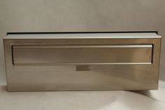 a stainless steel drawer on a white surface