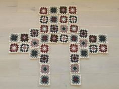 a crocheted cross is shown on the floor