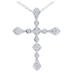 Diamond Carat Weight: This exquisite cross necklace boasts a total of 0.12 carats of diamonds. Adorned with 11 meticulously chosen round-cut diamonds, the necklace exudes a delicate brilliance and timeless charm. Gold Type: Crafted with precision in 14K white gold, the necklace embodies a perfect fusion of sophistication and purity. The white gold setting not only enhances the diamonds' radiance but also adds a contemporary touch to the classic cross design. Setting Style: The diamonds are elegantly cradled in bezel settings. This setting style offers a sleek and modern look, securely holding each diamond in place while creating a smooth and seamless appearance. The bezel setting is known for its protective and minimalist design. Gross Weight: Weighing a stylish 2.6 grams, the necklace str Touch Art, White Gold Set, Diamond Cross, Cross Design, Diamond Carat, Cross Designs, Round Cut Diamond, Diamond White, Chains Necklace