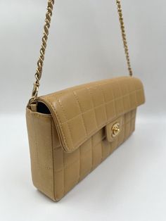 A beautiful Chanel Chocolate Bar Flap bag crafted using a beige coloured leather with gold coloured hardware. The chain drop is 31cm. This bag is in good vintage condition. There are some minor marks and creasing to the leather, please view all photos before buying. The bags lining is in very good condition and the serial number sticker is still attached. This bag also comes with its original Chanel box. The serial number tells us this bag was made between 2002-2003. Chanel Classic Medium, Bubble Quilt, Chanel Cambon, Chanel Box, Chanel Shoulder Bag, Number Stickers, Leather Baby, Colored Leather, Vintage Chanel