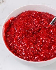 a white bowl filled with cranberry sauce