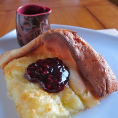 a piece of food on a plate next to a cup