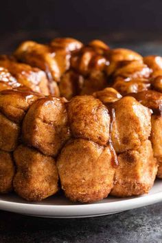 a monkey bread bundt cake on a plate with the words monkey bread gooey with hints of cinnamon