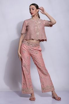 Peach short top with mughal jaal and chikankari hand embroidery. Comes with pant.
Component: 2
Pattern: Hand embroidered
Type Of Work: Mughal jaal, Chikankari
Neckline: Round
Sleeve Type: Half
Fabric: 25% Silk, 75% Cotton, Lining : Cotton
Color: Peach
Other Details: 
Closure : Hook and Eye
Occasion: Mehendi and Haldi - Aza Fashions Pink Bollywood Pant Set With Chikankari Embroidery, Pink Pant Set With Dabka Work For Diwali, Embroidered Peach Sets For Reception, Designer Peach Chikankari Embroidery Sets, Peach Chikankari Embroidery Designer Sets, Festive Peach Chikankari Embroidery Sets, Festive Peach Sets With Chikankari Embroidery, Peach Chikankari Embroidery Set, Eid Pink Straight Pants Set