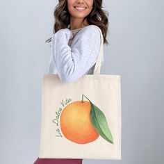 This cotton canvas shoulder tote bag featuring the phrase "La Dolce Vita" with a vibrant orange graphic is perfect for bringing a touch of Italy to your day. Ideal for weekend brunch, farmers market trips, or as a charming Italy-themed gift, this tote is as practical as it is stylish! Prefer this design on a T-Shirt? Visit this link: https://bohemianbloomdesigns.etsy.com/listing/1791107431/la-dolce-vita-shirt-buon-giorno-orange Prefer this design on a Sweatshirt? Visit this link: https://bohemianbloomdesigns.etsy.com/listing/1791109687/la-dolce-vita-buon-giorno-italy Prefer this design on a Baby Tee? Visit this link: https://bohemianbloomdesigns.etsy.com/listing/1791111229/la-dolce-vita-shirt-buon-giorno-preppy 🔑 Key Features: 100% Cotton Canvas: Strong and durable fabric made from spun f Orange Canvas Travel Bag, Large Capacity Orange Canvas Tote Bag, Large Capacity Orange Shoulder Canvas Bag, Orange Canvas Bag For Daily Use, Orange Canvas Shoulder Bag For Everyday Use, Orange Everyday Canvas Shoulder Bag, Orange Canvas Tote Bag For Daily Use, Orange Canvas Tote Bag, Orange Canvas Tote Shoulder Bag