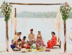 a group of people sitting around a table with food on it