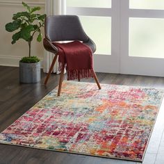 an area rug with a chair and potted plant