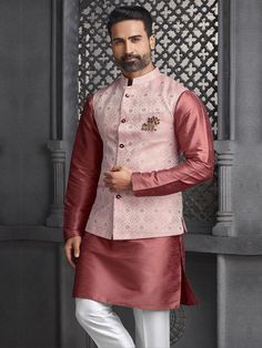 A Jacquard silk Nehru jacket with kurta pyjama in rust color is an excellent choice for wedding or festive wear. The Jacquard silk adds a luxurious texture and sheen, making it suitable for special occasions..To elevate the look further, you might consider coordinating the outfit with subtle gold or silver embellishments, or a matching stole. Adding traditional accessories, such as a brooch or a pair of stylish mojaris, can complete the ensemble perfectly.. Festive Pink Chanderi Nehru Jacket, Pink Chanderi Sherwani For Wedding, Festive Pink Nehru Jacket Straight Kurta, Pink Chanderi Long Sleeve Sherwani, Pink Nehru Jacket For Festive Occasions, Festive Banarasi Silk Bandhgala For Festivals, Festive Bandhgala In Banarasi Silk, Pink Nehru Jacket Straight Kurta For Diwali, Unstitched Brocade Nehru Jacket For Festivals