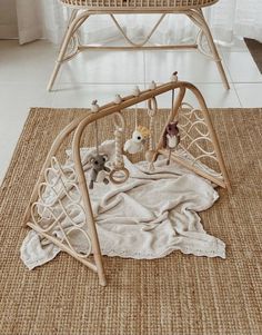 a baby crib with stuffed animals in it on a rug next to a window