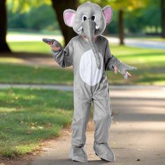 an elephant is standing in the middle of a sidewalk and wearing a gray suit with white circles on it's chest