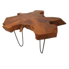 a wooden table with hairpin legs and a large piece of wood on the top