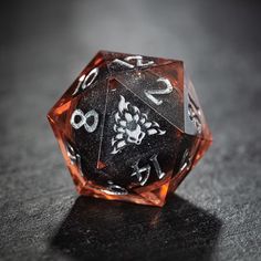 a black and white dice sitting on top of a table