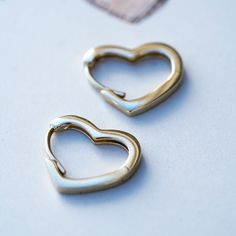 These darling 14k yellow gold heart earrings are just over .5" across and hang .5" from the post. The perfect combination of sweetness and elegance make these a great alternative to regular, gold hoops - perfect for everything from bridal jewelry to everyday wear. Not exactly what you're looking for? Check out our customs page. Available to try on in our Boulder, Colorado jewelry store. Gold Heart Earrings, Gold Heart Earring, Boulder Colorado, Gold Hoops, Gold Heart, Heart Of Gold, Heart Earrings, Jewelry Store, Try On