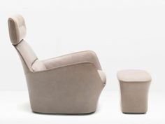 a white chair and footstool sitting next to each other on a white background