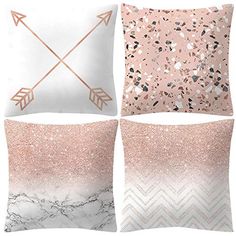 three pillows with gold glitter and arrows on the front, two white and one pink