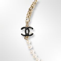 Trendy and Elegant design. Color: Black and pearly white. Glass pearls. Gold finished metal. Linked chain. Chain closure. Black and White “CC” logo linked. Pearls Necklace, Chanel Jewelry, Cc Logo, Design Color, White Glass, Gold Finish, Elegant Design, Pearl Necklace, Chanel