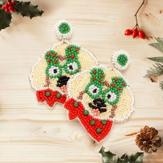 two christmas ornaments on a wooden table