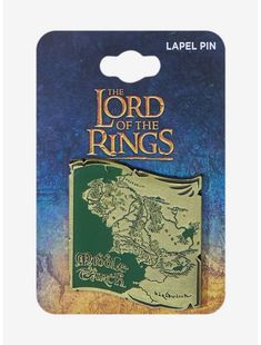 the lord of the rings lapel pin in gold and green on a blue background