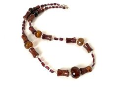 "The necklace is handcrafted using natural stones, specifically agate. MEASUREMENTS - The length of the open necklace is 56.5 cm. STONES - AGATA - belongs to the silicate mineral group and is a variety of quartz called chalcedony. It comes in many colors and various shades that are produced in the cavities of volcanic rocks. The name agate comes from the Greek \"achates\", name of the river where in ancient times were found multiple quantities of this stone. It is believed that the energetic force of these stones helps in relationships, instills courage by freeing from fear and oppression. Precisely for this reason, it was often given to warriors. DIASPRO is a variety of quartz quartz. It has a matte and compact stone. It can be of various colors depending on the inclusions present. It is Open Necklace, Silicate Minerals, Brown Necklace, Crystal Therapy, Tiger Eye Stone, Eye Stone, Hand Crafted Gifts, Ancient Times, Cavities