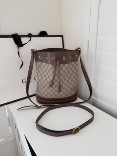 Gucci Bucket Bag - (does not come with Gucci Bag or extra strap) 10" W x 12"H x 5" D 100% Authentic Made in Italy  Interior is linen - has staining from meds when I travelled overseas - easy clean/press Store Policy: NO RETURNS ACCEPTED - All sales are final - please ask all questions prior to purchase as I do not take returns/exchanges/refunds Exterior has brushing/scratches/dirt - please view all photos  Does not come with box, strap or dust cloth etc. Gucci Leather Bucket Bag With Removable Pouch, Luxury Gucci Bucket Bag, Gucci Brown Bucket Bag, Gucci Luxury Bucket Bag With Removable Pouch, Gucci Bucket Bag, Gucci Bucket Bag With Gold-tone Hardware For Travel, Italy Interior, Clean And Press, Drawstring Bucket Bag