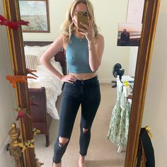 a woman standing in front of a mirror taking a selfie