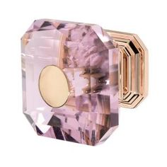 an image of a pink crystal doorknob with gold trimmings and a round knob